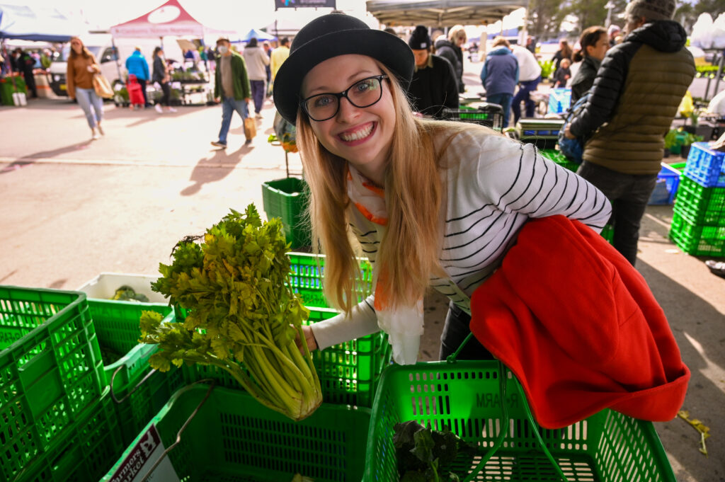 Getting started with a meal plan for neurodivergent eating by buying a big bunch of celery at a fresh fruit and vegetable market 