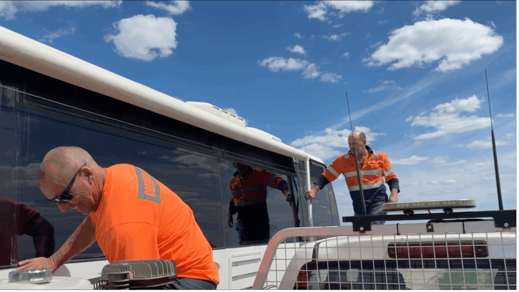 road workers helping fix the awning