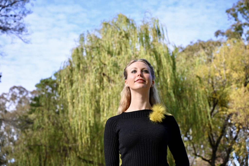 Confident creator smiling post-PMDD AuDHD flare, feeling regulated after writing rant.